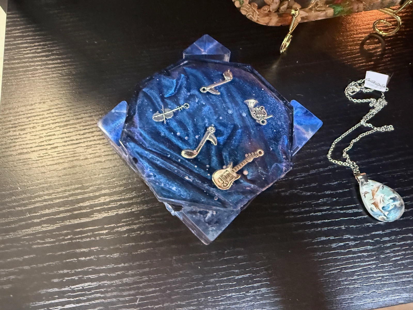 Deep blue galaxy resin dish with gold music charms — notes, violin, guitar, and horn